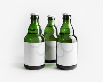 Three green beer bottles with blank labels.
