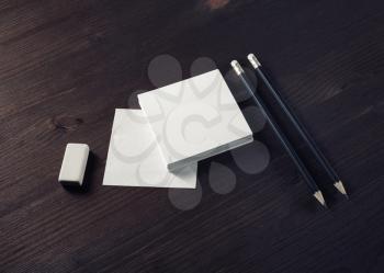 Blank notes, pencils and eraser on wood table background. Stationery mockup. Objects for placing your design.