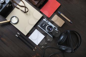 Travel or vacation concept. Old vintage camera and blank stationery on wooden background. Top view. Flat lay.