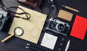 Vintage travel concept. Stationery with photo camera on wooden background. Top view. Flat lay.
