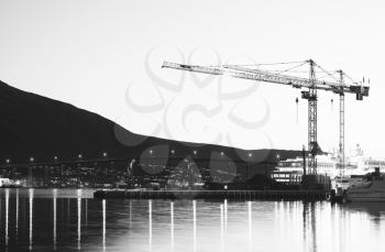 Building cranes in evening Tromso hd