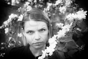 Horizontal black and white Russian beauty portrait in young garden background backdrop