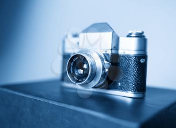 Diagonal vintage blue rangefinder camera background