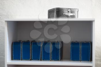 Black and white toy case with blue cases on the shelf background hd