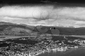 Black and white kite flyer above city background hd