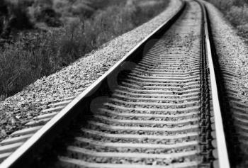 Diagonal black and white railroad track bokeh background