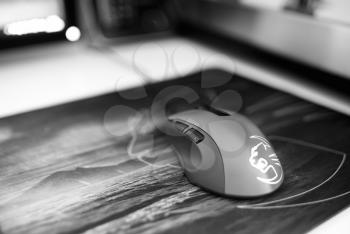 Black and white computer mouse on mousepad bokeh backdrop hd