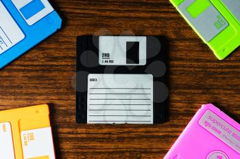 Vintage set of floppy discs on wooden desk background hd