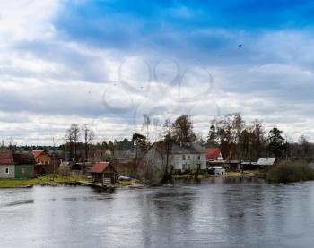 Horizontal dramatic houses on Karelian river bank  background backdrop
