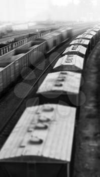 Vertical black and white toy train echelon bokeh background