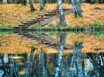 Dramatic park stairs with pond reflections landscape background