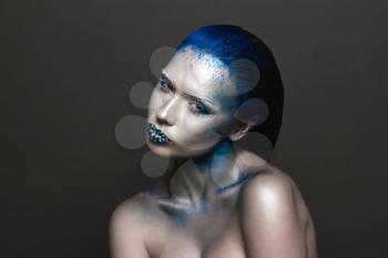 Cool Sexy Girl with Creative Festive Makeup. 
Art makeup with Blue Hair and Rhinestones on a Lips.