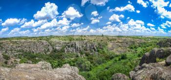 Panoramic view of deep granite Aktovo canyon with river and cloudy sky, One of the natural wonders of Ukraine.