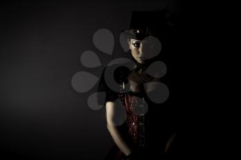 Emotional Portrait of Young Woman in Steampunk or Retro style. Studio shot. Model on a Black Background
