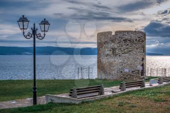 Nessebar, Bulgaria – 07.10.2019. Old Windmill on the promenade of Nessebar, Bulgaria, on a cloudy summer evening