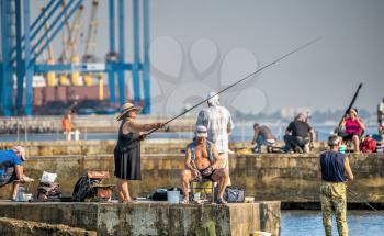 Odessa, Ukraine 09.03.2019. Fishermen on the Langeron beach in Odessa, Ukraine, on a sunny summer day