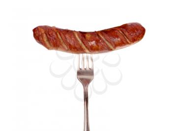 Grilled sausage on a fork isolated on white background
