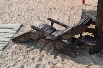 Wooden chaise lounge on the beach. Furniture for a beach holiday.