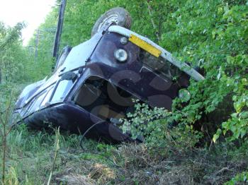 The car which moved down in a ditch as a result of accident. The turned car.