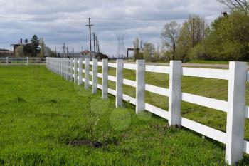 WhiteWhite wooden fence around the ranch. Wooden fence in the village. 