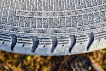 Hoarfrost on a rubber tire wheel. Morning frost.
