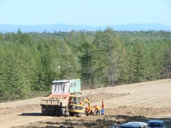 Sakhalin, Russia - Jul 18, 2014: Planning of the district under construction of the pipeline. Truck and excavator.                     