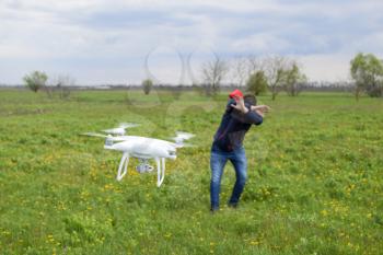 A man hides himself from a collision with a drone. Quadrocopter flies to the person.