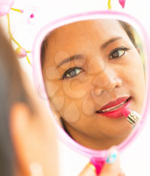 Applying Lipstick In Mirror Showing Beauty And Makeup
