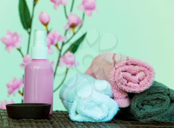 Spa Therapy Objects Including Towels Oil and Flowers
