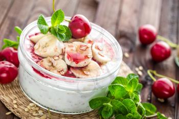 Fresh yogurt with cherry, banana and oats, delicious dessert for healthy breakfast