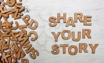 share your story It is written wooden letters