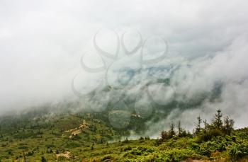 Fog in the mountains. Fog, rain over the forest, in mountains Carpathians, Ukraine.Dramatic sky.