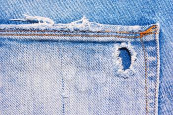 Back pocket of blue, ripped jeans, denim texture