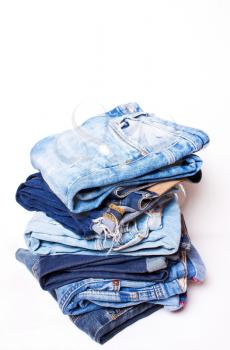 A few pairs of blue jeans on a white background. texture of denim