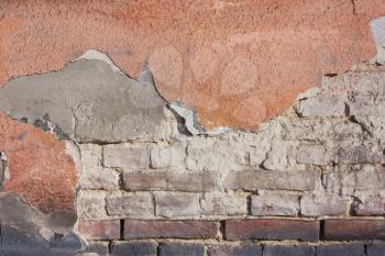 Old destroyed plaster at a brick wall. Grunge cement, with a shabby paint background.