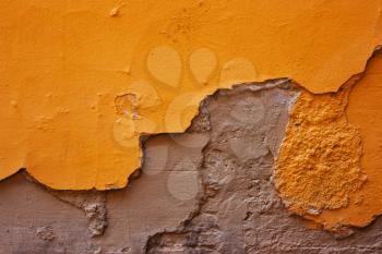yellow,Orange , gray destroyed plaster at a brick wall. Grunge cement, with a shabby paint background.