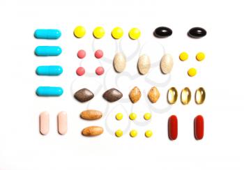 Vitamins, dietary supplements in a row on a white background, Background from multi-colored tablets.View from above, flat