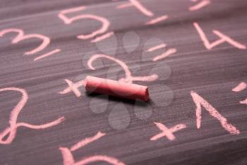 The pink chalk is written on the chalkboard. Concept of study, school, mathematics lessons, education