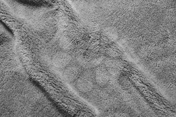 Gray soft  fleece texture. The surface of a teddy crumpled microfiber rug