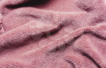 Pink soft fleece texture. The surface of a teddy crumpled microfiber rug