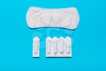 Medical, vaginal suppositories on a blue background, from candidiasis, thrush, sexually transmitted infections