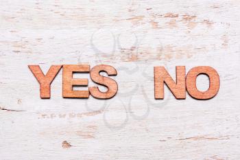 Words yes or no in wooden letters. The concept of choice, decision, consent, denial