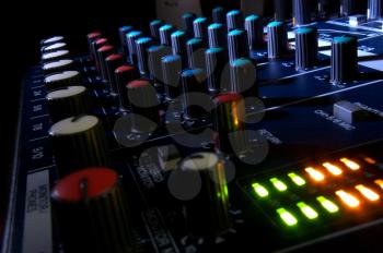 Mixing console at night. Musical background.