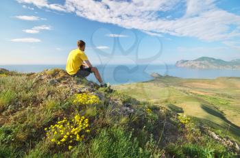 Man looking on the sea and mountain landscape.