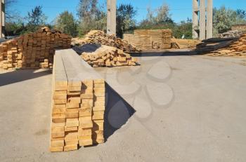 Wood in an outdoor pine wood warehouse. Building industry scene.