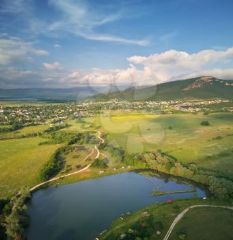Scenic aerial view of beautiful landscape of the valley Hills and lake on sunset. 