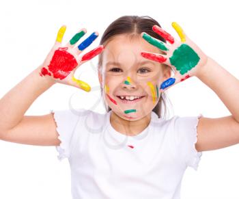 Cute girl showing her hands painted in bright colors, isolated over white