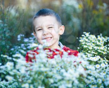 Cute little boy in park.Flowers