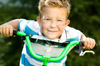 Happy boy riding a bicycle in the park
