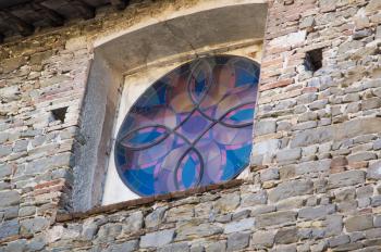 details of architecture, historical buildings of Italy. Stone walls and delicate stained glass Window.